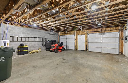 basement/garage, garage doors, concrete flooring, block walls