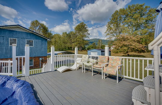 gated/fenced pool deck, back yard, trees