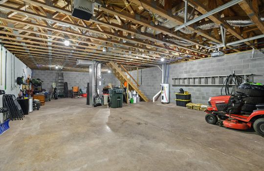 basement/garage, water heater, block walls, concrete flooring