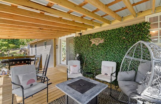 back deck, covered back deck, wood deck, faux greenery feature wall, exterior door