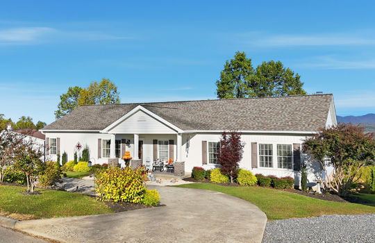 modular home, detached garage, driveway, covered front porch, mountain views