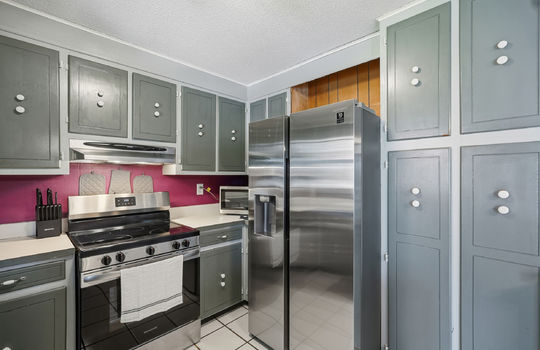 kitchen, cabinets, countertops, stainless appliances, oven/range, refrigerator, tile flooring