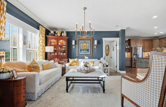 living room, open floorplan, luxury vinyl flooring, chandelier, windows