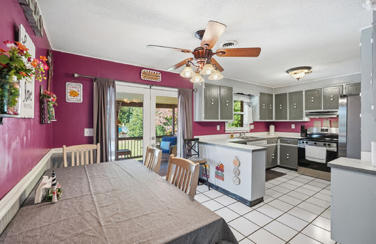 kitchen/dining combo, tile flooring, ceiling fan, door to back deck, cabinets, countertops, sink, dishwasher, oven/range, refrigerator, door to back deck