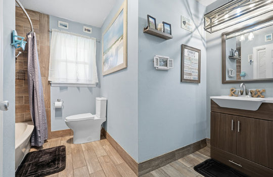 shower/tub, tile flooring, toilet, sink, tile shower