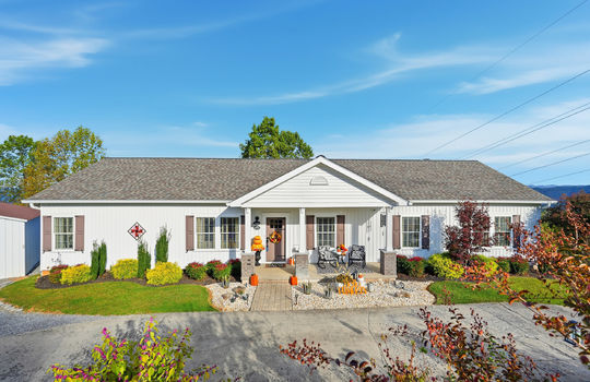 modular home, driveway, sidewalk, landscaping, covered front porch, vinyl siding