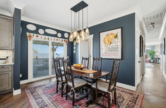 dining area, chandelier, exterior door to back deck, luxury vinyl flooring, hallway
