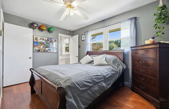 primary bedroom, hardwood flooring, ceiling fan, ensuite bathroom