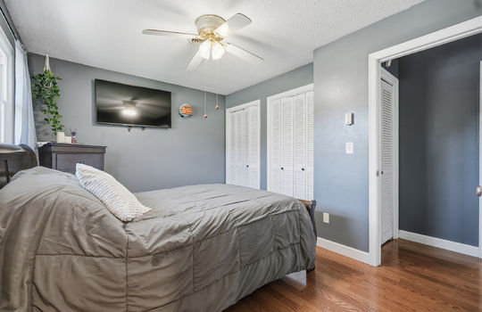 primary bedroom, ceiling fan, double closets, hardwood flooring