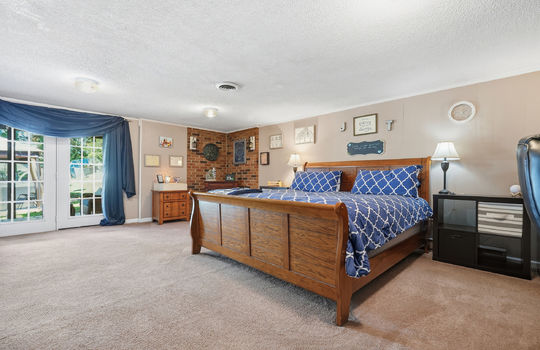 lower level bedroom, carpet, patio door