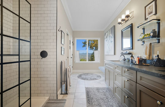 primary bathroom, dual vanity sink, shower, tile flooring, window