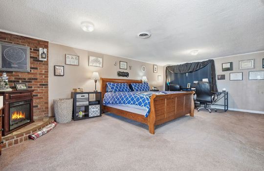 lower level bedroom, carpet, brick feature wall