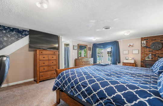 lower level bedroom, carpet, patio door