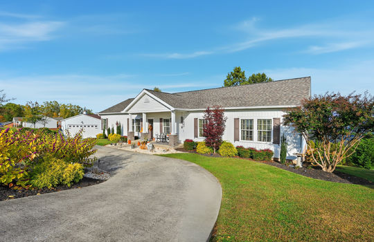 modular home, covered front porch, landscaping, driveway, detached garage, front yard