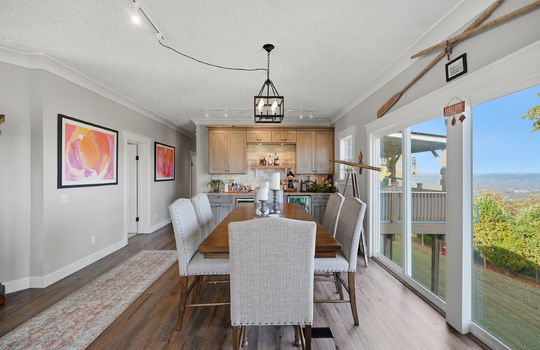 family room, wet bar, sink, tile backsplash, wine cooler, mini fridge, large windows, mountain views, luxury vinyl flooring, hallway