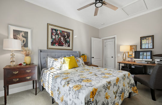 bedroom, carpet, ceiling fan, door to hallway