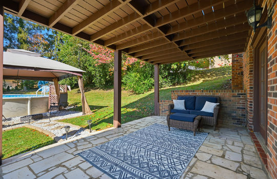 back patio, stone patio, entry door, above ground swimming pool, back yard