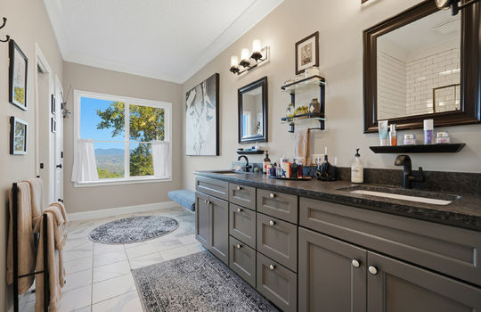 primary bathroom, dual vanity sink, tile flooring, window, mountain views