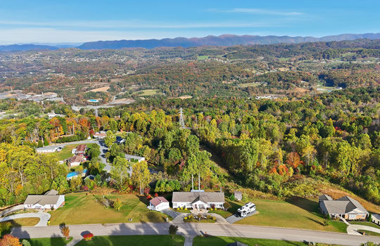 aerial photo, property, road, modular home, RV parking, detached garage, mountain views, neighboring homes