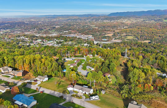 aerial photo, property, road, modular home, RV parking, detached garage, mountain views, neighboring homes