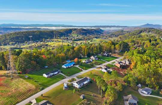 aerial photo, property, road, modular home, RV parking, detached garage, mountain views, neighboring homes