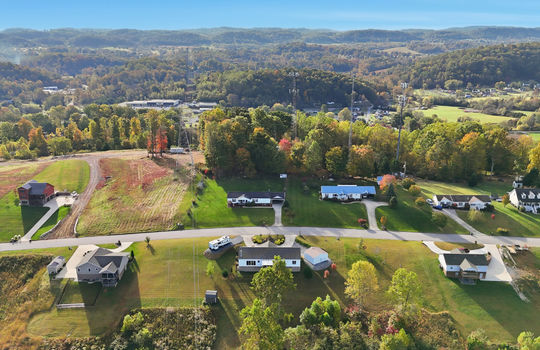 aerial photo, property, road, modular home, RV parking, detached garage, mountain views, neighboring homes