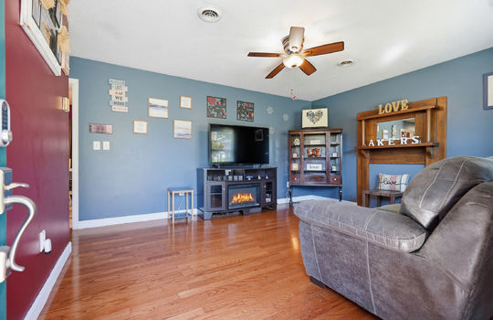 living room, hardwood flooring, ceiling fan