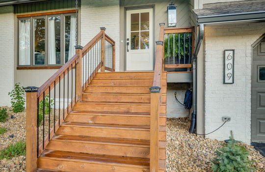 front steps, brick exterior, wood exterior, front door, landscaping