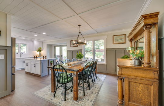 kitchen, eat-in kitchen, luxury vinyl flooring, chandelier, recessed lighting, kitchen island, kitchen sink, window, door to back yard, windows