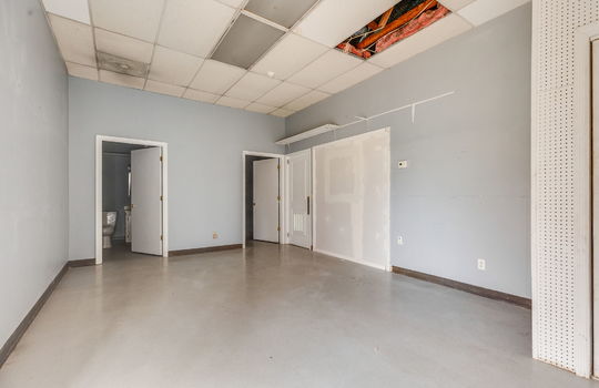 employee bathroom, employee breakroom/private office/ back office space, storage, tile flooring, ceiling tiles, fluorescent lighting