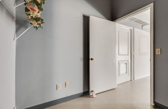 private office space, storage space, tile flooring, door to breakroom/storage space