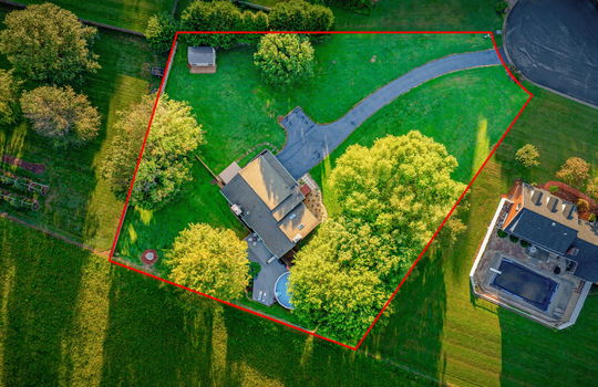 Aerial overhead photo of home, approximate property outline, driveway, home, fencing, back yard, trees, landscaping