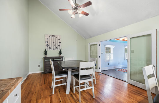 dining area, vaulted ceiling, hardwood flooring, double doors sunroom