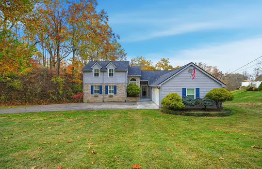 traditional style home, front yard, landscaping, driveway, front door, wood siding, brick, trees