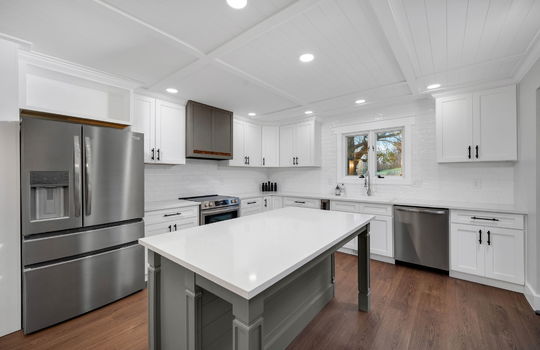 kitchen, refrigerator, kitchen island, stone countertops, cabinets, refrigerator, oven/range, sink, dishwasher, cabinets, recessed lighting