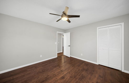 bedroom, ceiling fan, luxury vinyl flooring, closet door