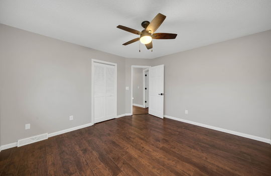 bedroom, ceiling fan, luxury vinyl flooring, closet door