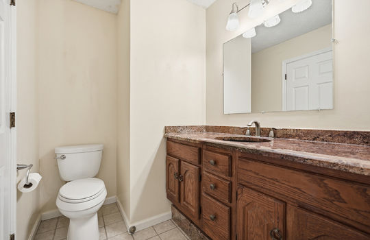 second ensuite bathroom, toilet, granite countertop, sink, tile flooring, cabinet