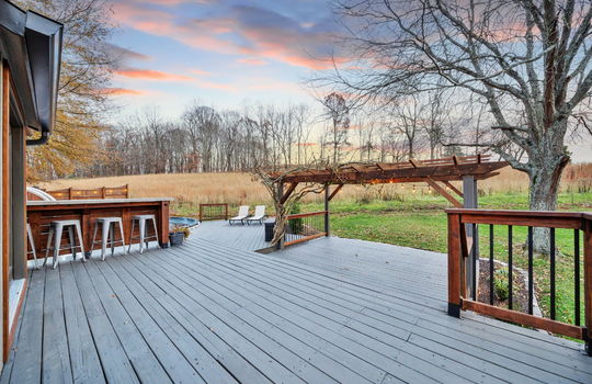back deck, bar seating, pergola, landscaping, trees