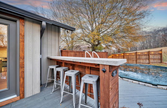 back deck, bar seating overlooking pool, fencing