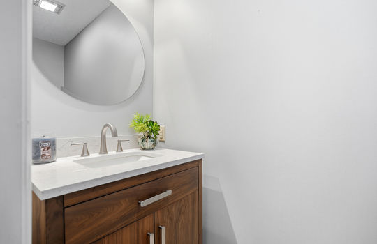 half bath, sink, granite countertops, cabinet