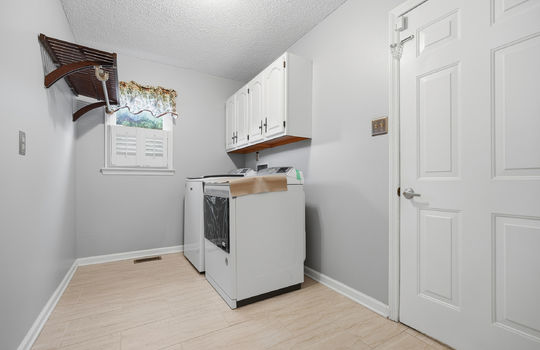 laundry area, washer/dryer hookups, cabinets, window, shelving