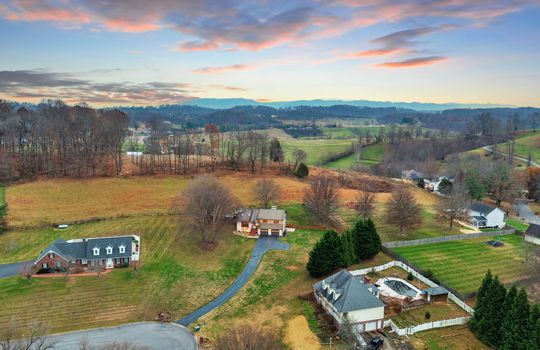 aerial view of home, neighboring homes, driveway, contemporary home, mountain views