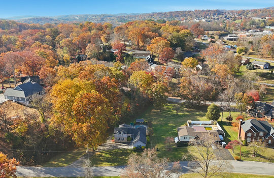 aerial photo of home, road, driveway, trees, back yard, neighboring homes,