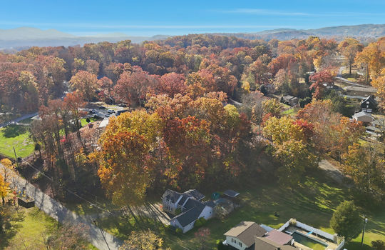aerial photo of home, road, driveway, trees, back yard, neighboring homes, mountains