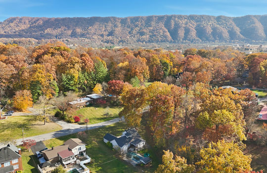 aerial photo of home, road, driveway, trees, back yard, neighboring homes, mountains
