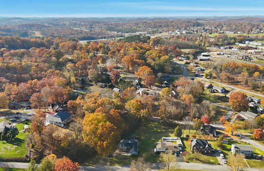 aerial photo of home, road, driveway, trees, back yard, neighboring homes, mountains