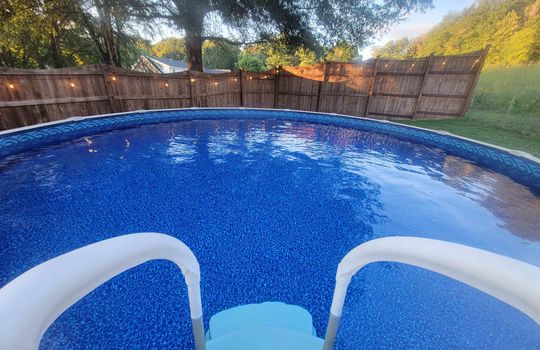 above ground pool in summer, fencing, fence lights
