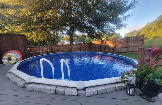above ground pool in summer, fencing, fence lights