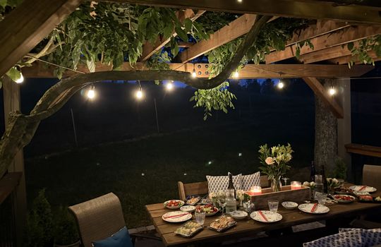nighttime staged photo of pergola, lights